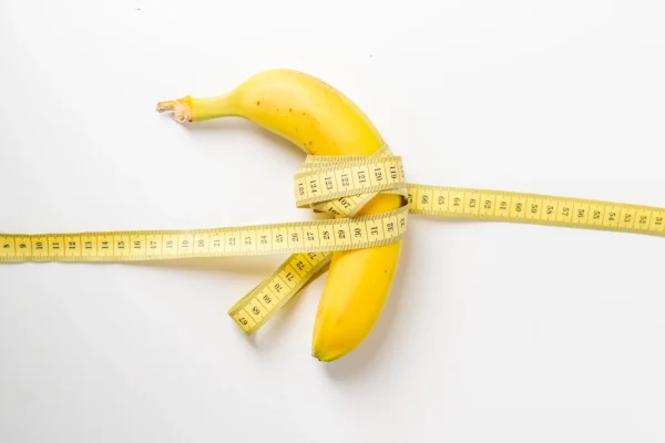 fruit-and-centimeter-tape-on-white-surface