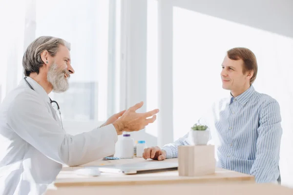 male-patient-consults-with-doctor-in-office-