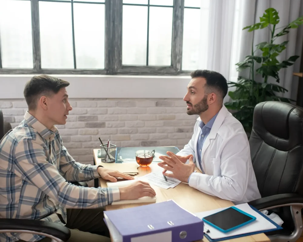 patient-in-checkered-shirt-explaining-his-problems
