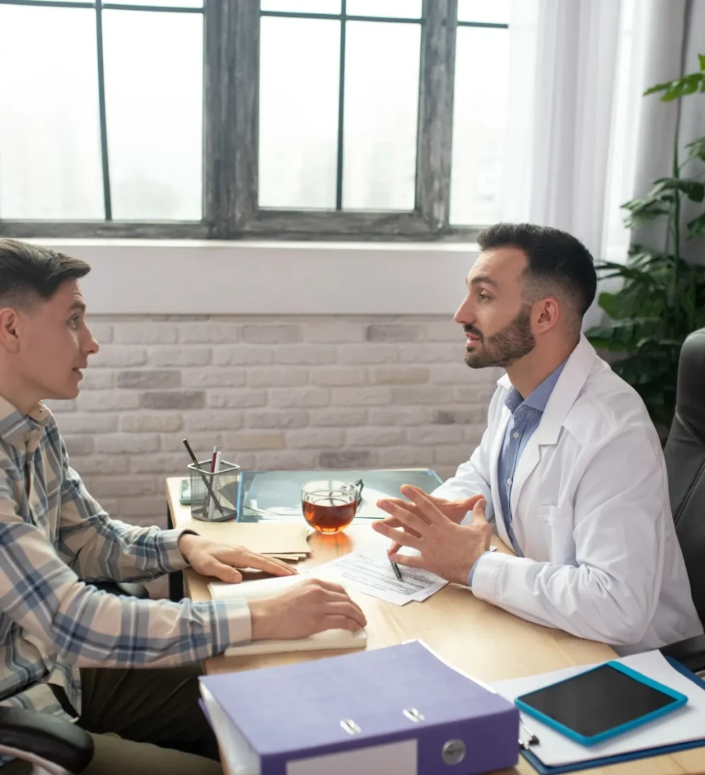 patient-in-checkered-shirt-explaining-his-problems